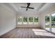Sunroom with hardwood floors and multiple windows at 209 Brush Ct., Little River, SC 29566
