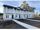 Three-unit townhome building, featuring gray siding, stone accents, and private balconies at 850 Maxine Ct. # 5C, Myrtle Beach, SC 29577