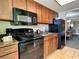 Well-equipped kitchen with wood cabinets and black appliances at 1105 S Ocean Blvd. # 940, Myrtle Beach, SC 29577