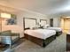 Hotel bedroom with two double beds and comfortable seating at 1105 S Ocean Blvd. # 940, Myrtle Beach, SC 29577