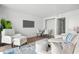Living room with white furniture, wood floors, and TV at 2207 S Ocean Blvd. # 1015, Myrtle Beach, SC 29577