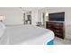 King-size bed, dresser, and view of kitchenette at 2207 S Ocean Blvd. # 309, Myrtle Beach, SC 29577
