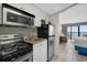 Small condo kitchen with microwave, stove, and refrigerator at 2207 S Ocean Blvd. # 309, Myrtle Beach, SC 29577