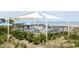 Elevated deck overlooking the beach with shaded seating area at Tbd Old Cypress Circle, Pawleys Island, SC 29585
