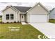 Beige one-story house with a two-car garage at 2819 Biscane Ct., Conway, SC 29527