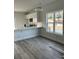 Modern kitchen featuring white cabinets, gray vinyl flooring, and a breakfast bar at 821 Maxine Ct. # 2D, Myrtle Beach, SC 29577