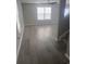 Living room with gray vinyl plank flooring and large windows at 219 Oak Leaf Dr., Longs, SC 29568