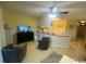 Living room with two armchairs, TV, and kitchen view at 1880 Colony Dr. # 12-F, Surfside Beach, SC 29575