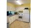 Galley kitchen with white cabinets, appliances, and tile floor at 1880 Colony Dr. # 12-F, Surfside Beach, SC 29575