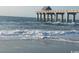 Ocean waves rolling onto sandy beach near pier at 1880 Colony Dr. # 12-F, Surfside Beach, SC 29575