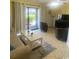 Living room with sofa, chairs, coffee table, and patio access at 1880 Colony Dr. # 12-F, Surfside Beach, SC 29575