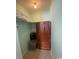 Small closet with wood wardrobe and overhead shelving at 1880 Colony Dr. # 12-F, Surfside Beach, SC 29575