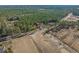 Wide aerial view showing the home's location in a rural, wooded setting at 6174 Highway 66, Loris, SC 29569