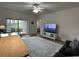 Living room with patio access and large TV at 4843 Luster Leaf Circle # 102, Myrtle Beach, SC 29577