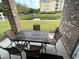 Relaxing patio with table and chairs overlooking a pond at 4843 Luster Leaf Circle # 102, Myrtle Beach, SC 29577