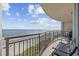 Balcony with ocean view, seating, and glass railings at 603 S Ocean Blvd. # 1011, North Myrtle Beach, SC 29582