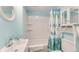 Clean bathroom with a tub shower, white vanity, and seashell theme at 1418 S Ocean Blvd., North Myrtle Beach, SC 29582