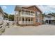 Two-story brick house with porch, walkway, and parking area at 1418 S Ocean Blvd., North Myrtle Beach, SC 29582