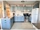 Compact kitchen with light blue cabinets and stainless steel appliances at 5905 S Kings Hwy. # 337B, Myrtle Beach, SC 29575