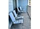 Private balcony with four blue chairs and side table at 5905 S Kings Hwy. # 337B, Myrtle Beach, SC 29575