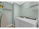 Bright laundry room with washer, dryer, and ample shelving at 1010 Perrin Dr., North Myrtle Beach, SC 29582