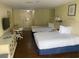 Two beds, dresser, and small table in a condo bedroom at 1207 S Ocean Blvd. # 50512, Myrtle Beach, SC 29577