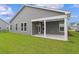 Gray house with covered patio and green lawn at 1906 Woodrush Loop, Little River, SC 29566