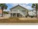 Two-story house with a green exterior, deck, and landscaping at 1906 S Ocean Blvd., North Myrtle Beach, SC 29582