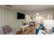 Living room with sofa, TV, and adjacent dining area at 1906 S Ocean Blvd., North Myrtle Beach, SC 29582