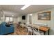 Open living area with teal couch and dining table at 1906 S Ocean Blvd., North Myrtle Beach, SC 29582