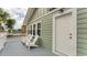 Inviting exterior with a private deck, three white chairs, and a light green exterior at 1906 S Ocean Blvd., North Myrtle Beach, SC 29582