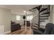 Living room with spiral staircase and seating at 1906 S Ocean Blvd., North Myrtle Beach, SC 29582