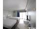 Bright bedroom with two beds, a TV, and access to a balcony at 1207 S Ocean Blvd. # 20606, Myrtle Beach, SC 29577