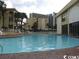 Enjoy this large outdoor pool with surrounding buildings and landscaping at 1207 S Ocean Blvd. # 20606, Myrtle Beach, SC 29577