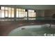 Enjoy this indoor pool with adjacent hot tub and brick flooring at 1207 S Ocean Blvd. # 20606, Myrtle Beach, SC 29577