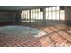 Indoor pool and hot tub area with large windows and brick flooring at 1207 S Ocean Blvd. # 20203, Myrtle Beach, SC 29577