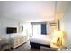 King-size bed, dresser, and a TV in a bright hotel room at 1207 S Ocean Blvd. # 20203, Myrtle Beach, SC 29577