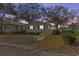 Single story home with a ramp, viewed at dusk at 6001 - Mh197 South Kings Hwy., Myrtle Beach, SC 29575