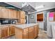 Kitchen features an island, wood cabinets, and stainless steel appliances at 6001 - Mh197 South Kings Hwy., Myrtle Beach, SC 29575