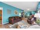 Living room with teal walls, brown couch, and hardwood floors at 6001 - Mh197 South Kings Hwy., Myrtle Beach, SC 29575