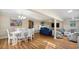 Open dining area with white table and chairs, adjacent to living space at 304 2Nd Ave. S, North Myrtle Beach, SC 29582