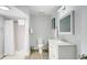 Updated bathroom with white vanity, shower, and gray tile floor at 304 2Nd Ave. S, North Myrtle Beach, SC 29582