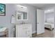 Clean bathroom with white vanity, mirror and a view into bedroom at 304 2Nd Ave. S, North Myrtle Beach, SC 29582