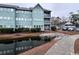 Building exterior with pond, walkway, and parking area at 5905 South Kings Hwy. # 6110-D, Myrtle Beach, SC 29575