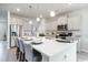 Open kitchen with island, white cabinets, and stainless steel appliances at 263 Lassoed Circle, Murrells Inlet, SC 29576