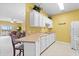 Cozy kitchen features white cabinets and a breakfast bar at 2050 Cross Gate Blvd. # 303, Myrtle Beach, SC 29575