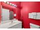 Clean bathroom with white vanity, red walls, and shower/tub combo at 2050 Cross Gate Blvd. # 303, Myrtle Beach, SC 29575