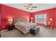 Red-walled bedroom with king-size bed and sitting chair at 2050 Cross Gate Blvd. # 303, Myrtle Beach, SC 29575