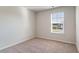 Well-lit bedroom with neutral walls, carpet, and a window with blinds at 153 Teddy Bear Circle, Conway, SC 29526