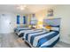 Guest bedroom with two twin beds, dresser, and entrance to the hallway at 2201 S Ocean Blvd. # 1705, Myrtle Beach, SC 29577